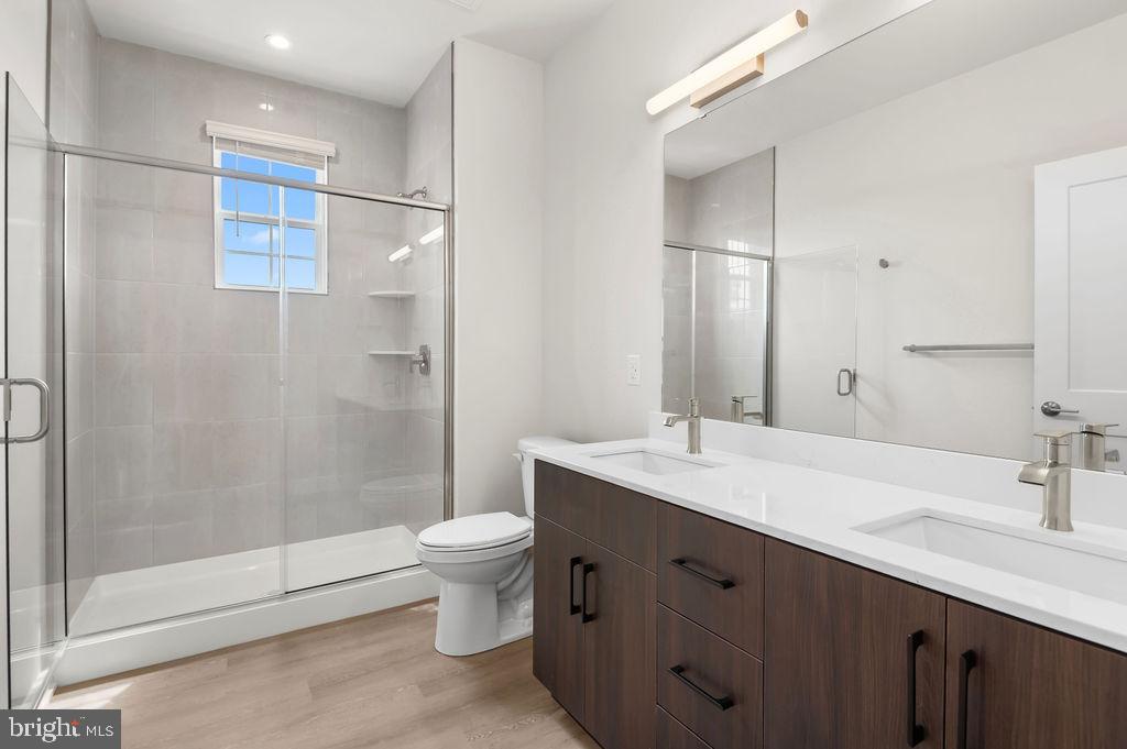 26 South York Road, Unit 210 Hatboro, PA 19040 - Photo 11 of 52 a bathroom with a double vanity sink toilet and shower