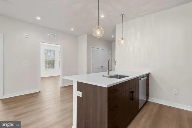 a kitchen with stainless steel appliances a refrigerator sink and microwave