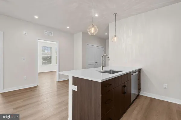 a kitchen with stainless steel appliances a refrigerator sink and microwave