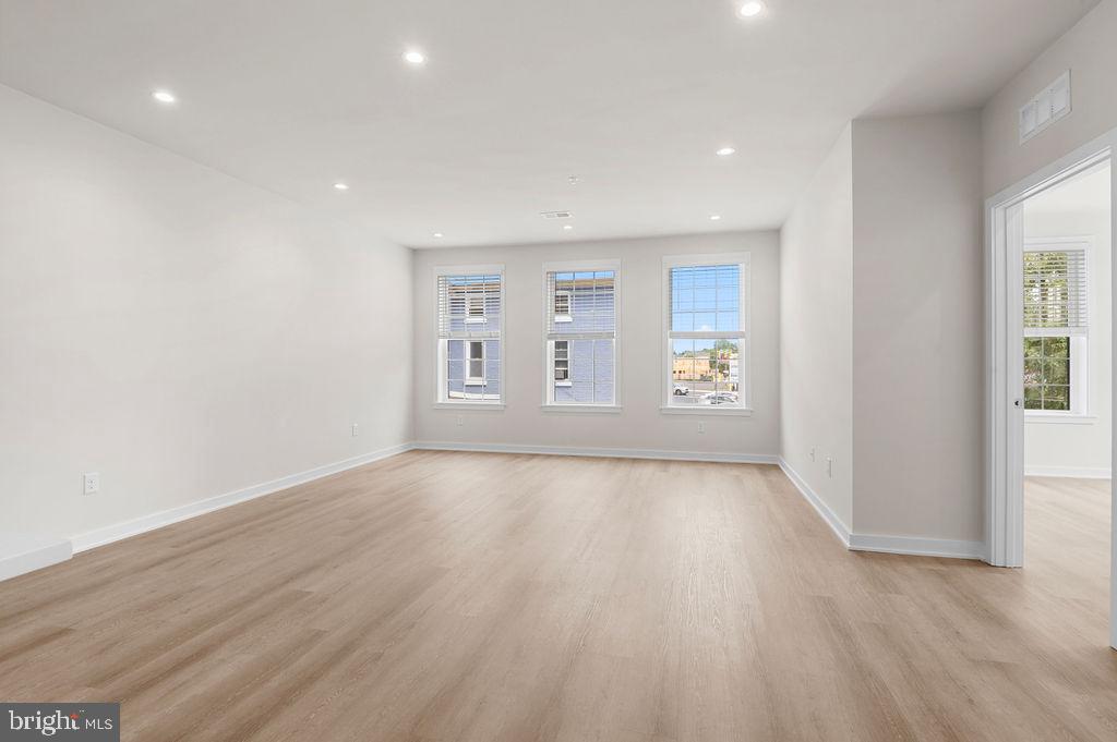 26 South York Road, Unit 210 Hatboro, PA 19040 - Photo 16 of 51 an empty room with wooden floor and windows