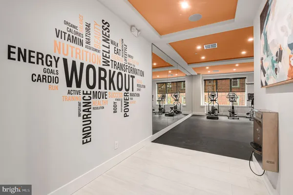 a room with gym equipment and a flat screen tv