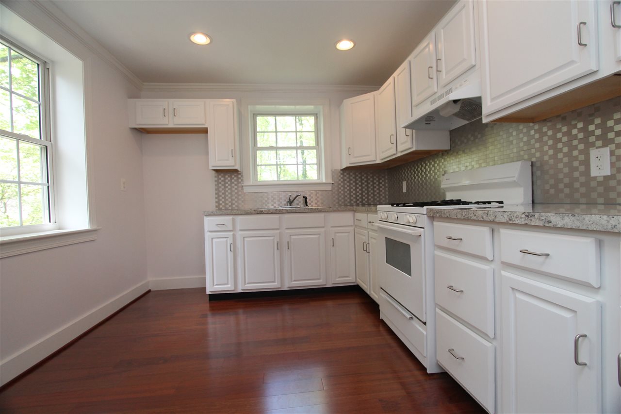 211 Shamrock Road Charlottesville, VA 22903 - Photo 3 of 9 a kitchen with stainless steel appliances a white stove top oven sink and cabinets