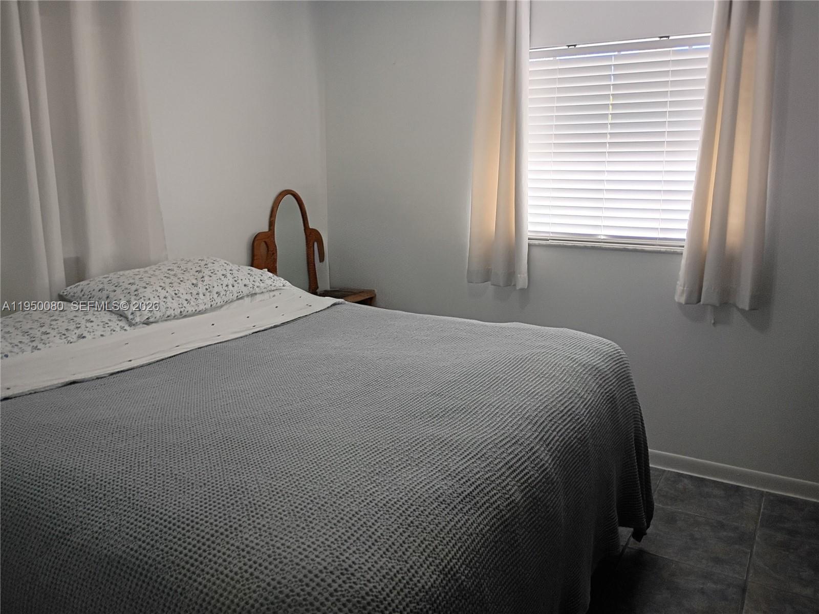 1824 Red Road Clewiston, FL 33440 - Photo 11 of 27 a bedroom with a bed and a window