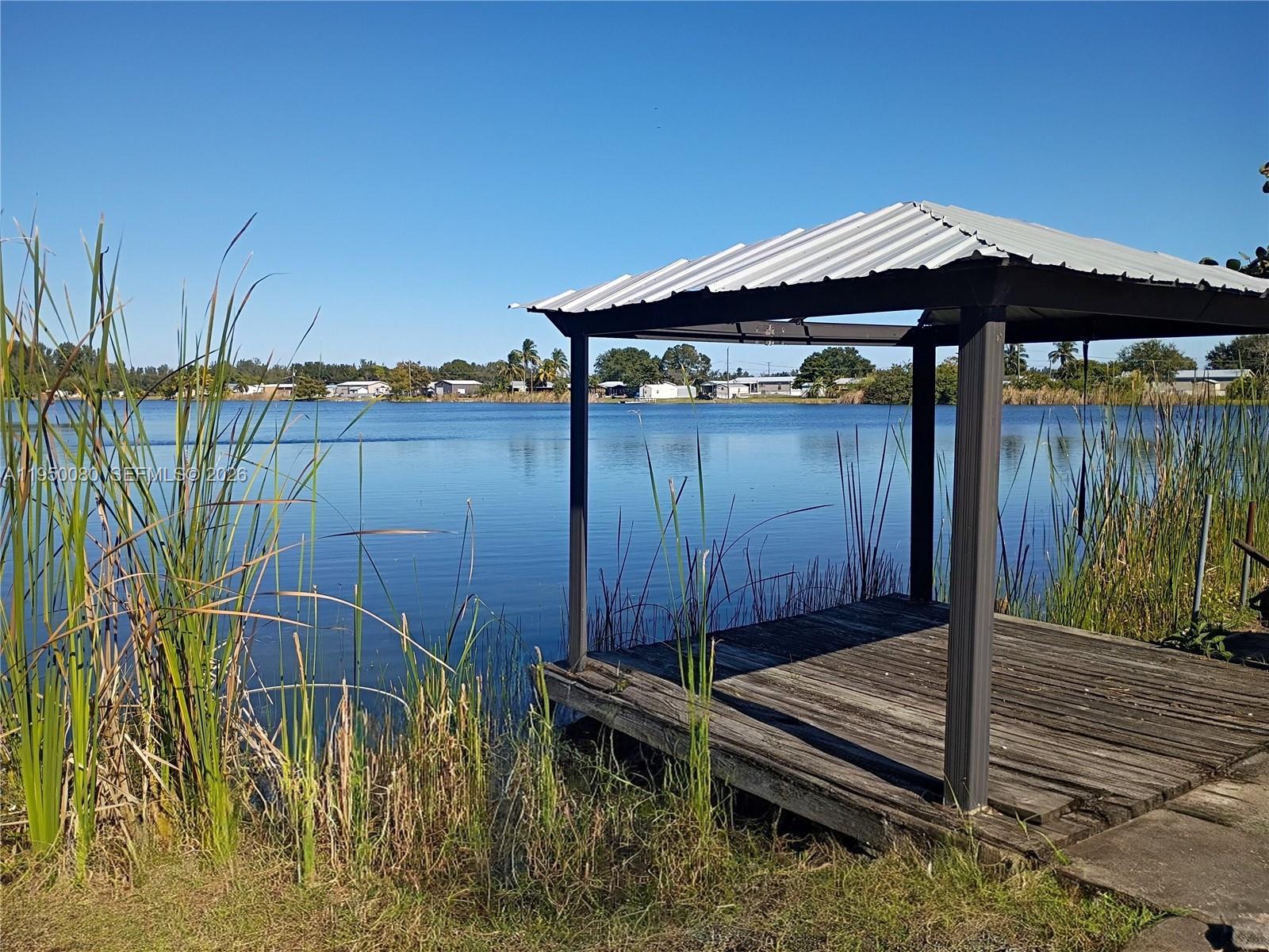 1824 Red Road Clewiston, FL 33440 - Photo 20 of 27 a front view of a house with garden