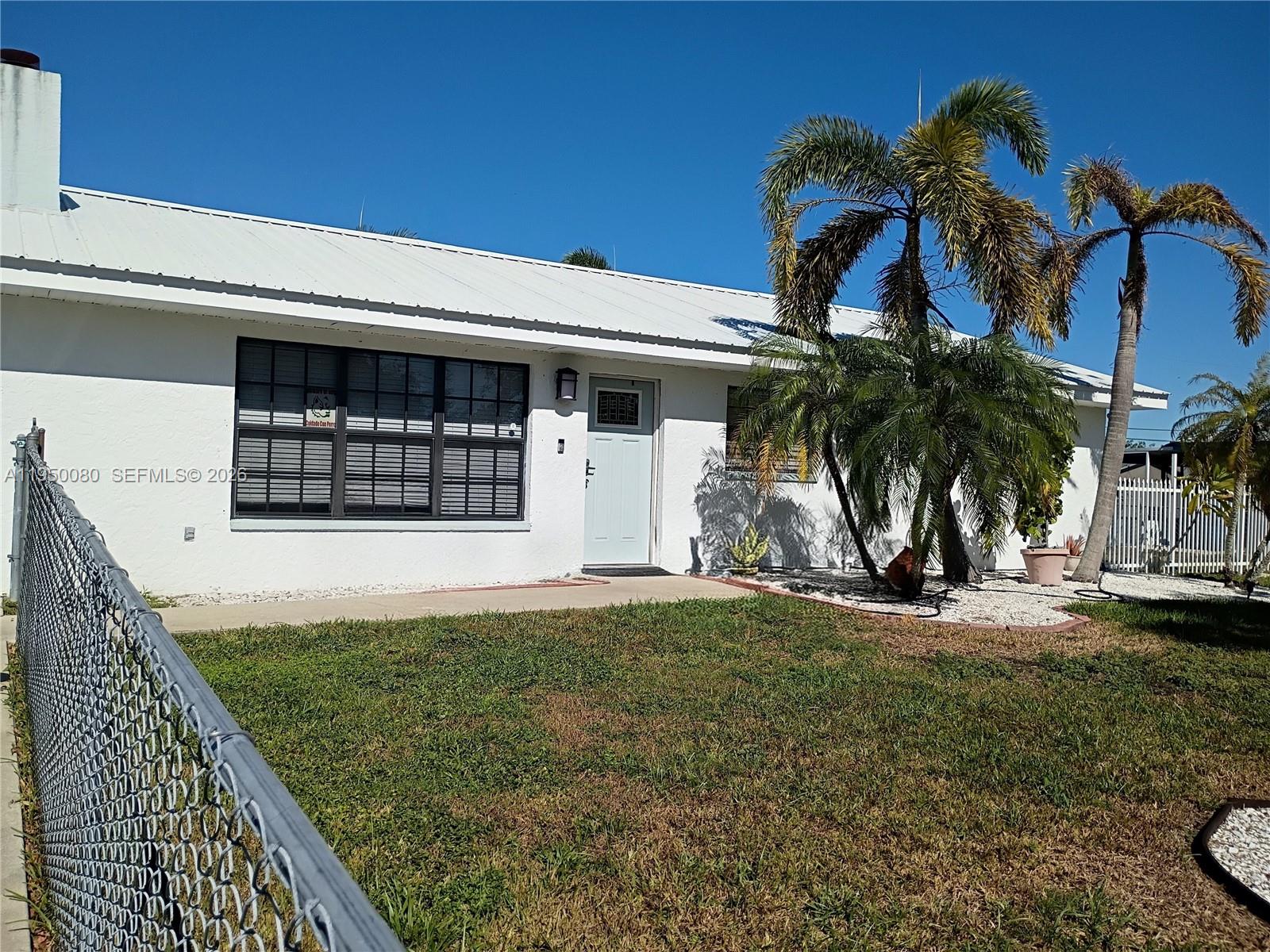 1824 Red Road Clewiston, FL 33440 - Photo 2 of 27 a front view of a house with a yard