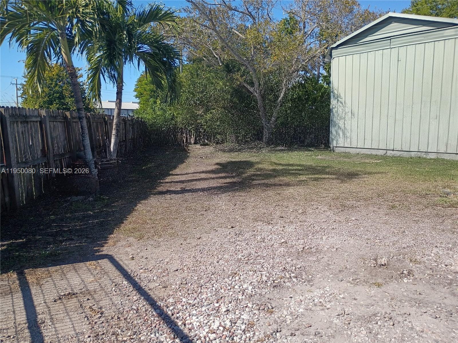 1824 Red Road Clewiston, FL 33440 - Photo 24 of 27 a backyard of a house with lots of green space
