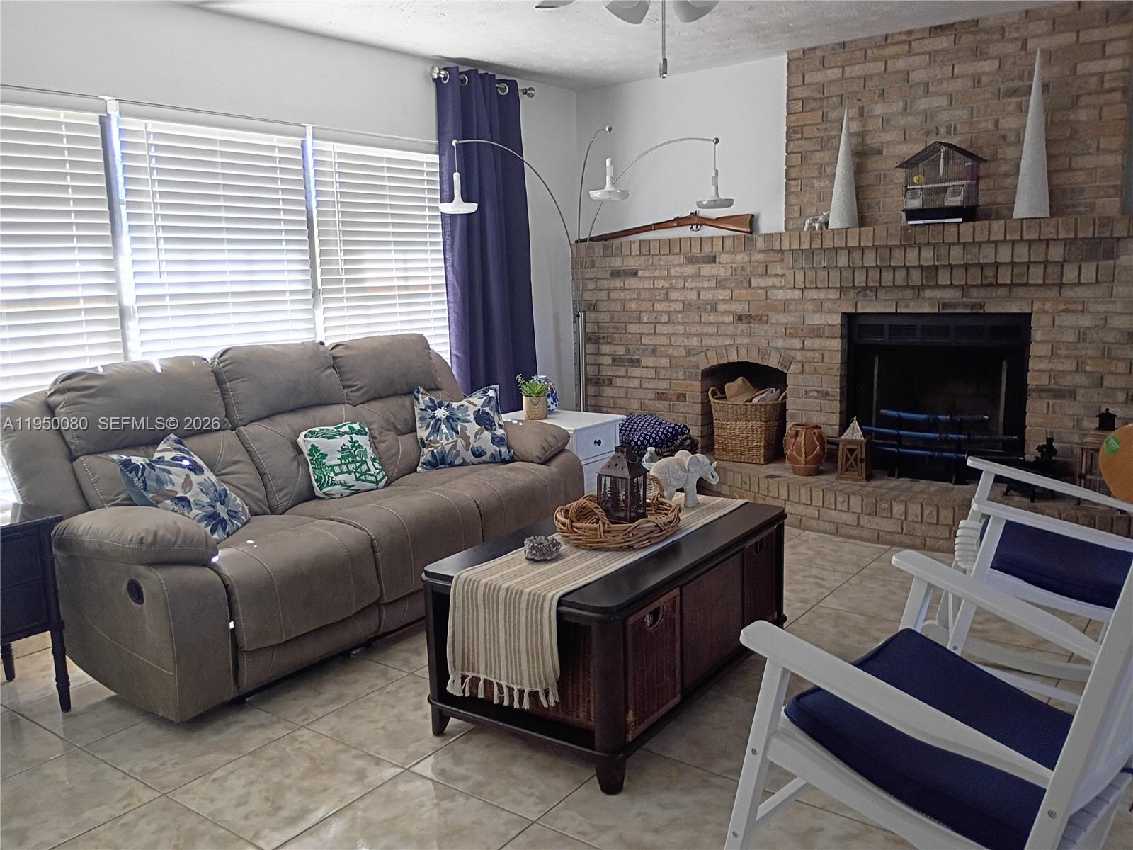 1824 Red Road Clewiston, FL 33440 - Photo 3 of 27 a living room with furniture and a fireplace