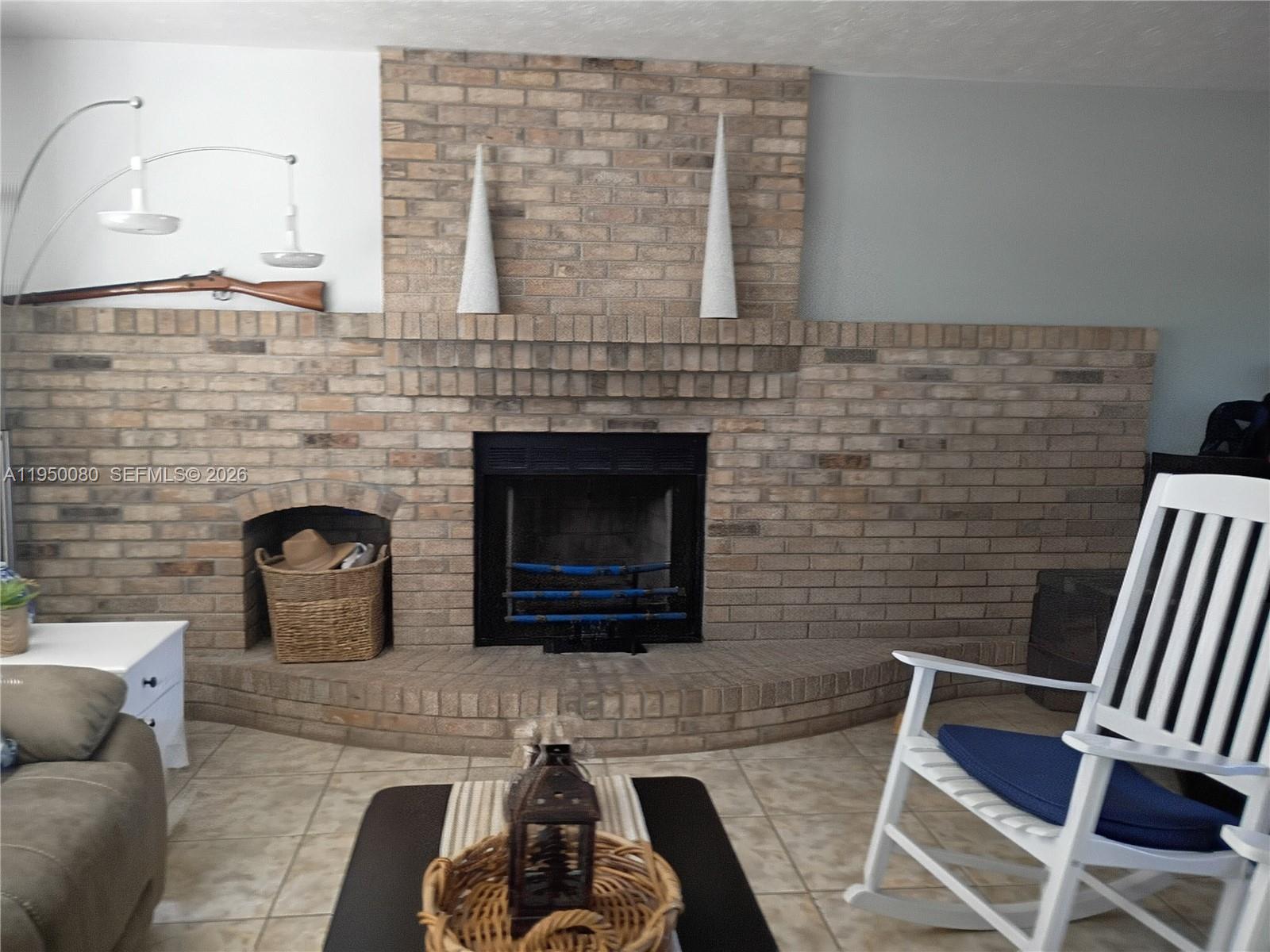 1824 Red Road Clewiston, FL 33440 - Photo 4 of 27 a living room with furniture and a fireplace