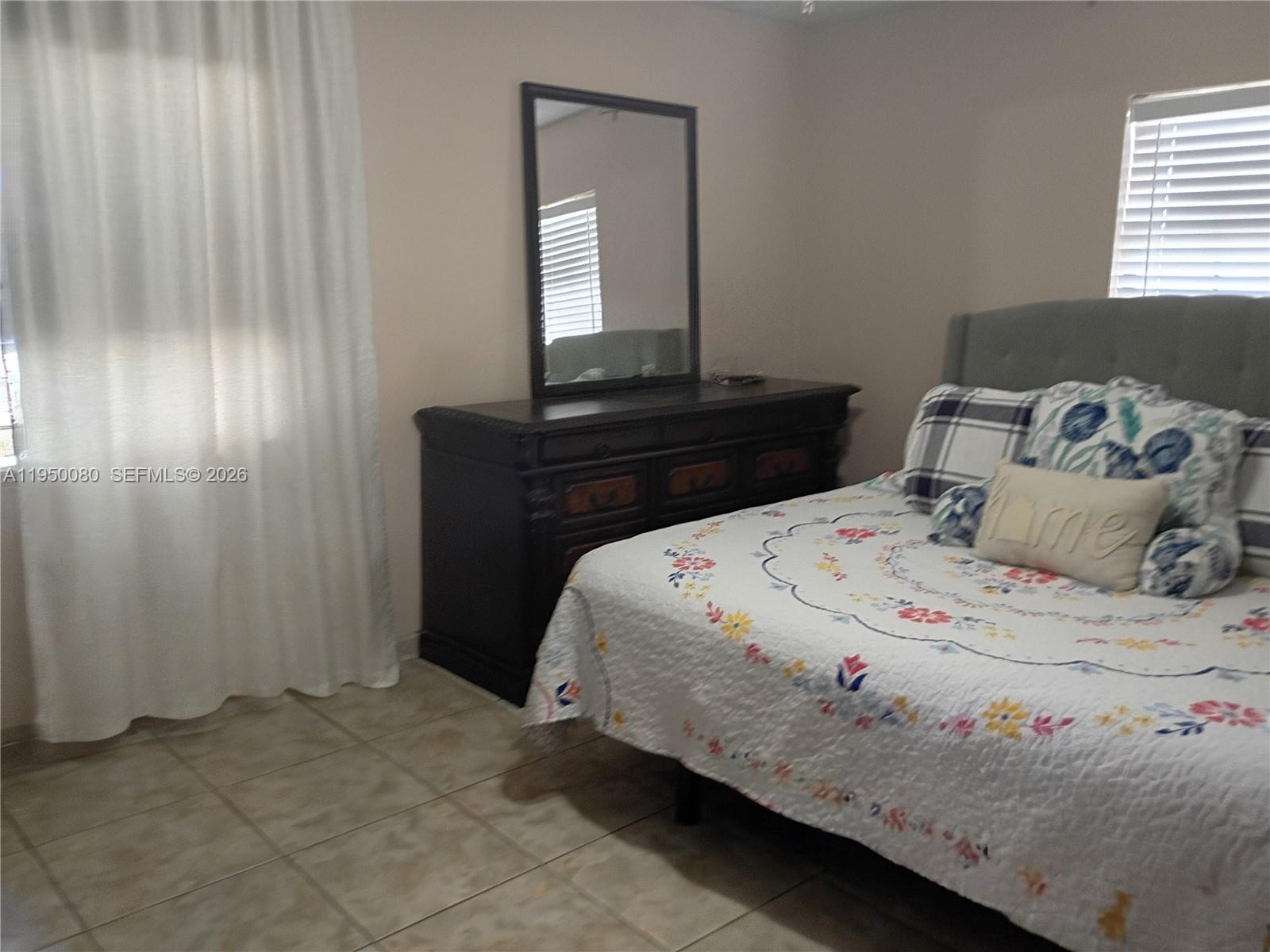 1824 Red Road Clewiston, FL 33440 - Photo 9 of 27 a bedroom with a bed and a window