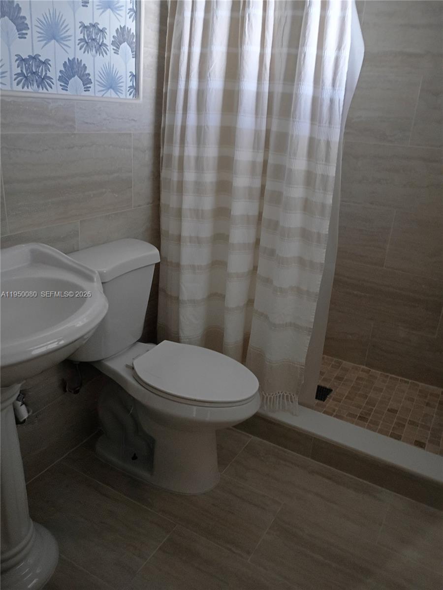 1824 Red Road Clewiston, FL 33440 - Photo 10 of 27 a white toilet sitting next to a bathroom sink