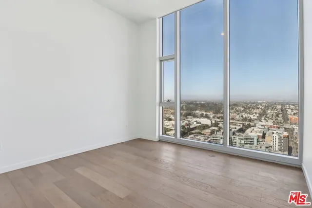 an empty room with wooden floor and door