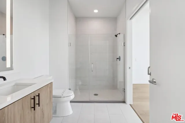 a bathroom with a shower and a sink
