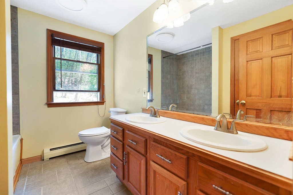 20 Upper Hampden Road Monson, MA 01057 - Photo 24 of 39 a bathroom with a double vanity sink toilet and mirror