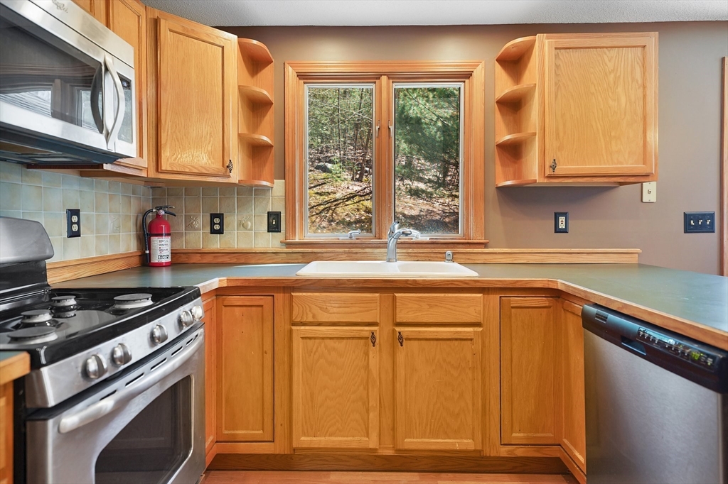 20 Upper Hampden Road Monson, MA 01057 - Photo 7 of 39 a kitchen with stainless steel appliances granite countertop a sink stove and cabinets