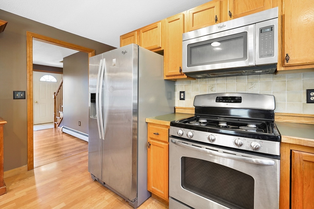 20 Upper Hampden Road Monson, MA 01057 - Photo 8 of 39 a kitchen with stainless steel appliances granite countertop a stove microwave and cabinets