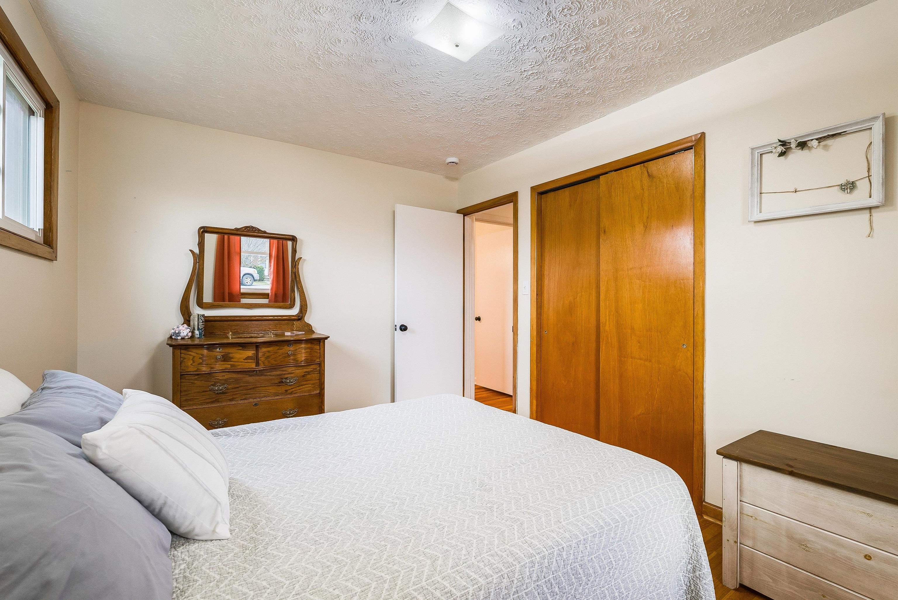 815 Rutherford Street Staunton, VA 24401 - Photo 27 of 56 a bedroom with a bed and a lamp on dresser