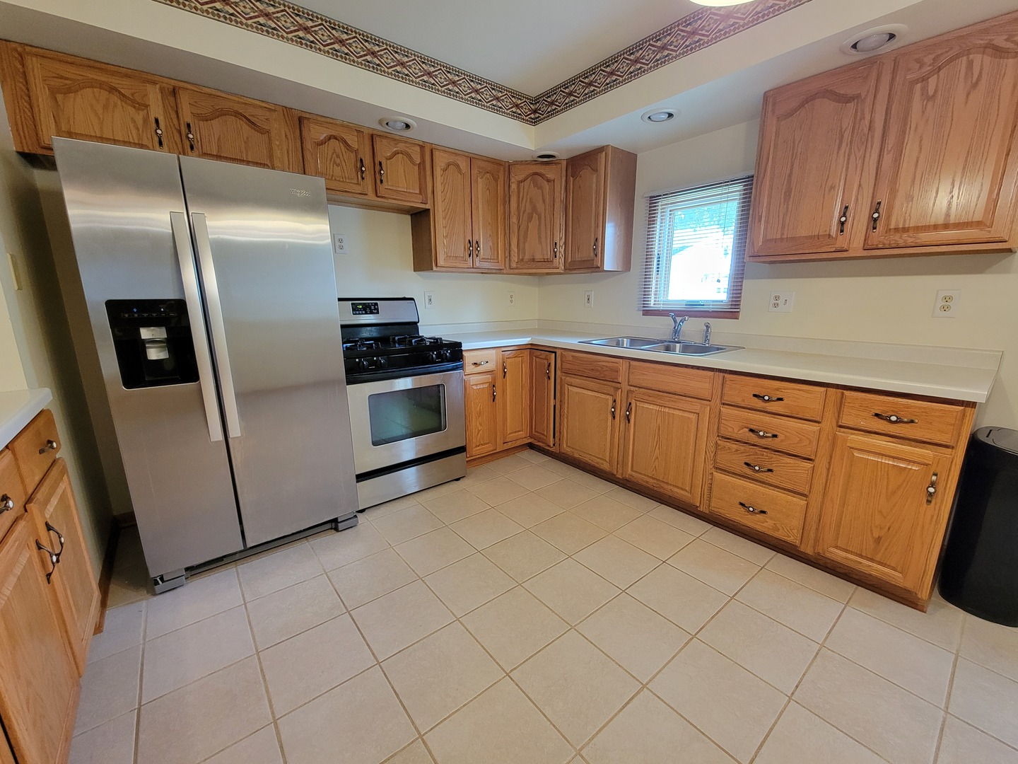 208 Nebraska Street, Unit A Ottawa, IL 61350 - Photo 2 of 14 a kitchen with stainless steel appliances granite countertop a refrigerator and a stove top oven