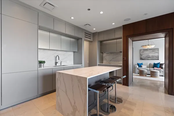a kitchen with a table chairs refrigerator and cabinets