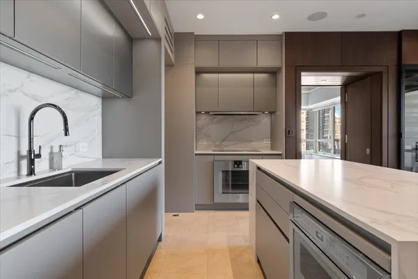 a kitchen with stainless steel appliances granite countertop a sink and a refrigerator