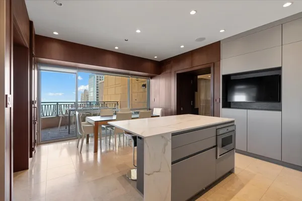 a room with a table chairs and a flat screen tv