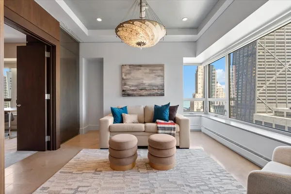 a living room with furniture windows and a chandelier