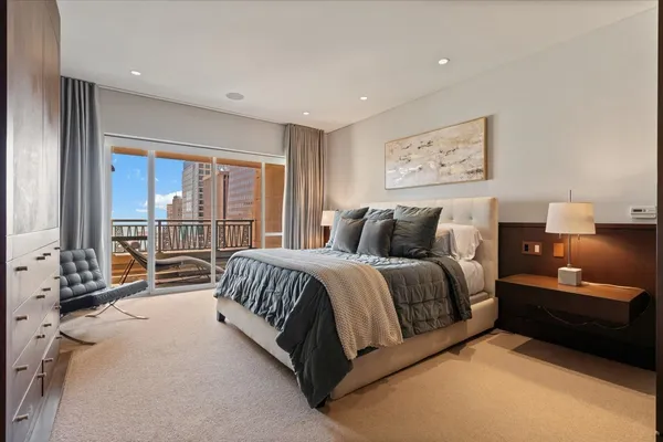 a spacious bedroom with a bed and glass door