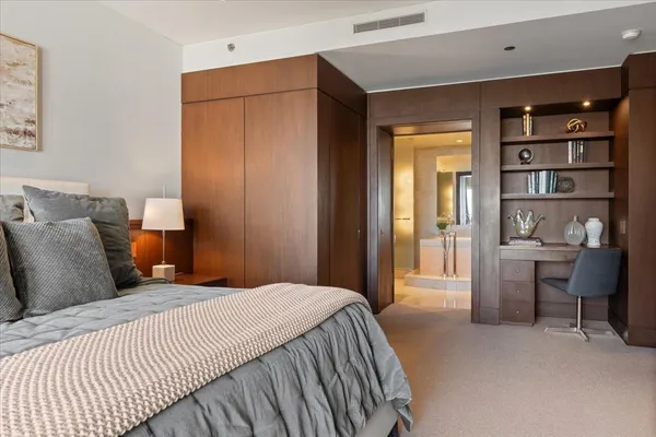 a bedroom with a large bed and a cabinets