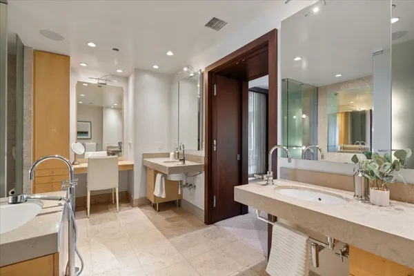 a bathroom with a double vanity sink and a mirror