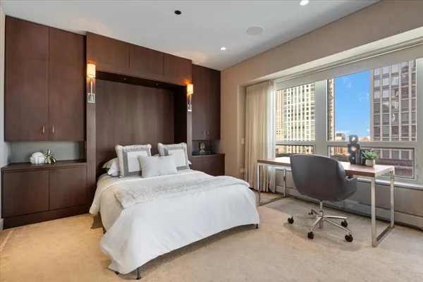 a bedroom with a bed and a chair