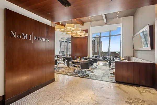 a view of a hallway with couch and mirror