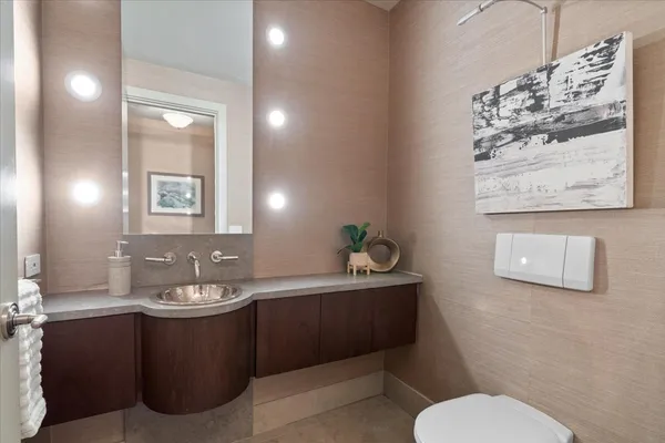 a bathroom with a toilet sink and mirror