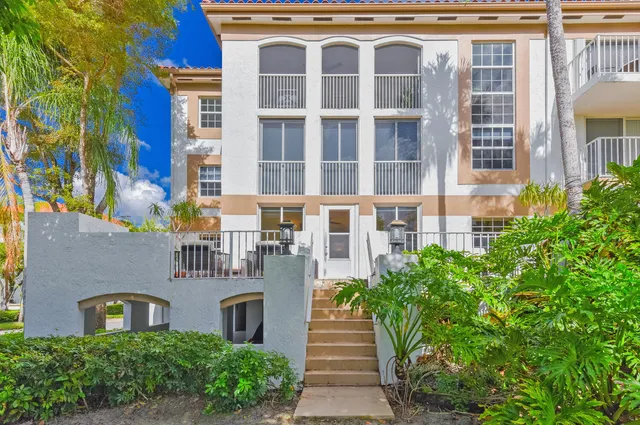 a front view of a building with a garden