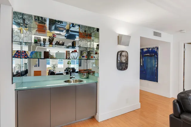 a kitchen with stainless steel appliances granite countertop a sink stove microwave and refrigerator