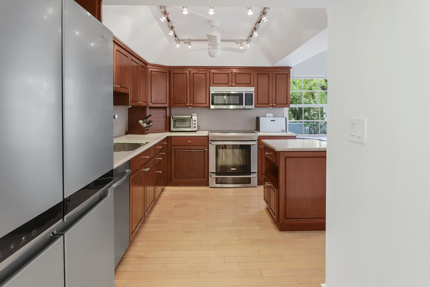 7369 Orangewood Lane, Unit 108 Boca Raton, FL 33433 - Photo 12 of 66 a large kitchen with stainless steel appliances granite countertop a sink and cabinets