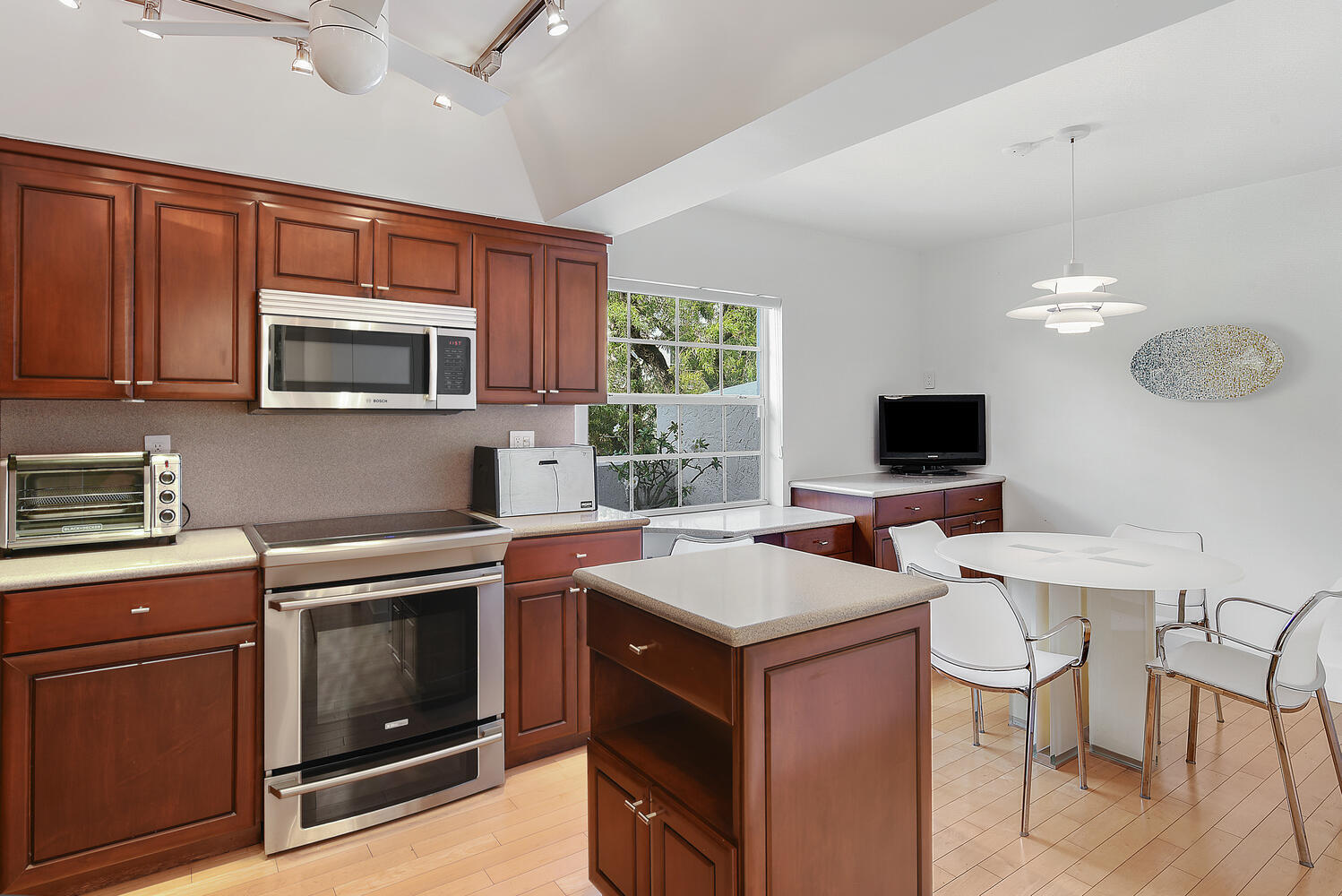 7369 Orangewood Lane, Unit 108 Boca Raton, FL 33433 - Photo 13 of 66 a kitchen with a stove a sink and a microwave