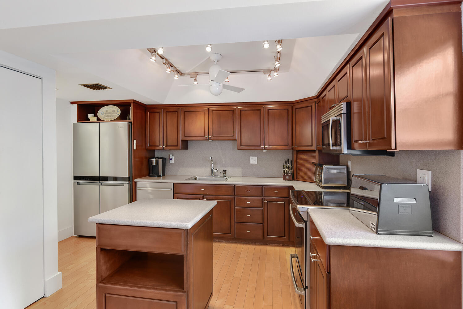7369 Orangewood Lane, Unit 108 Boca Raton, FL 33433 - Photo 14 of 66 a kitchen with stainless steel appliances granite countertop a refrigerator a stove a sink dishwasher a microwave oven with cabinets and wooden floor