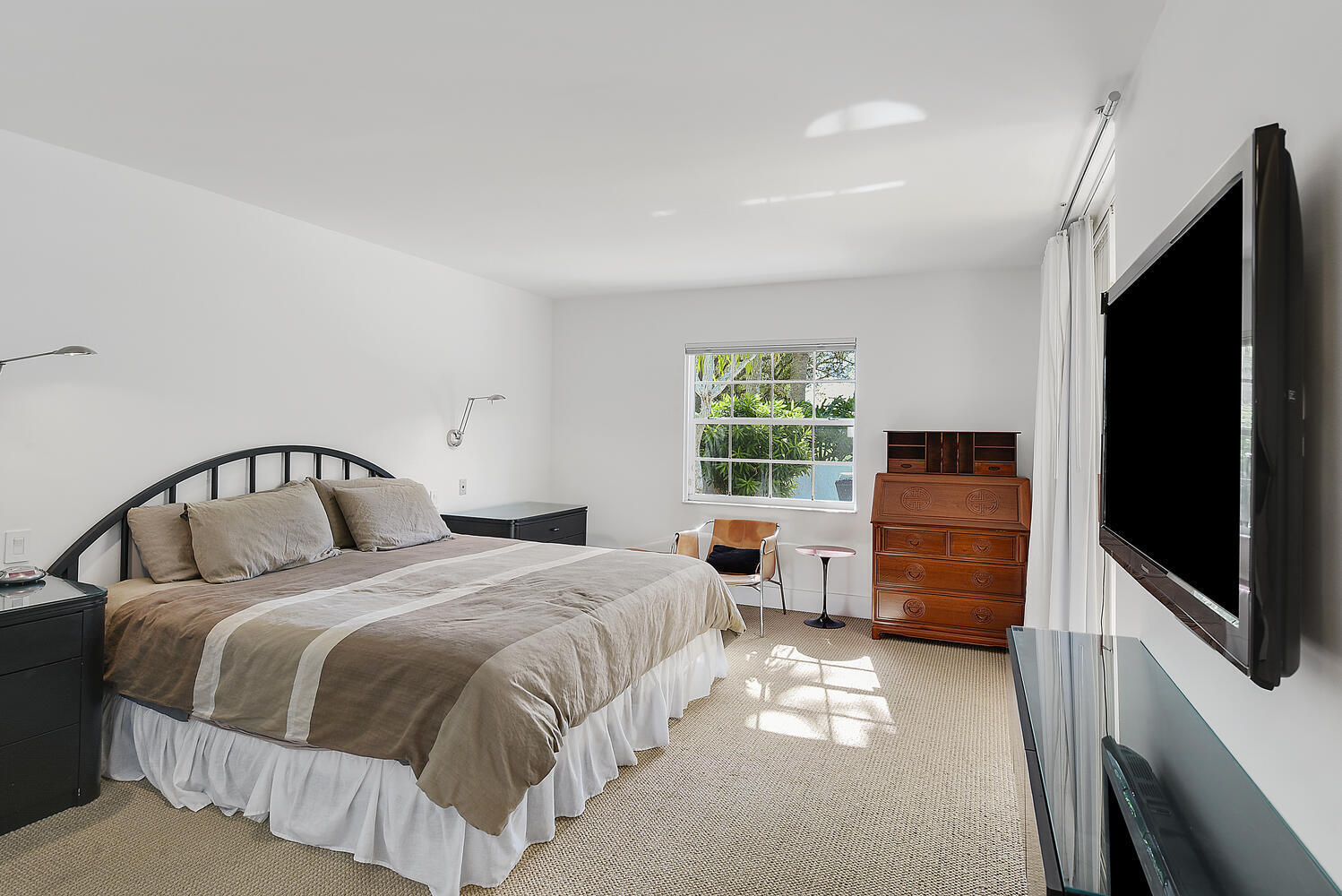 7369 Orangewood Lane, Unit 108 Boca Raton, FL 33433 - Photo 18 of 66 a bedroom with a large bed and a flat tv screen on dresser