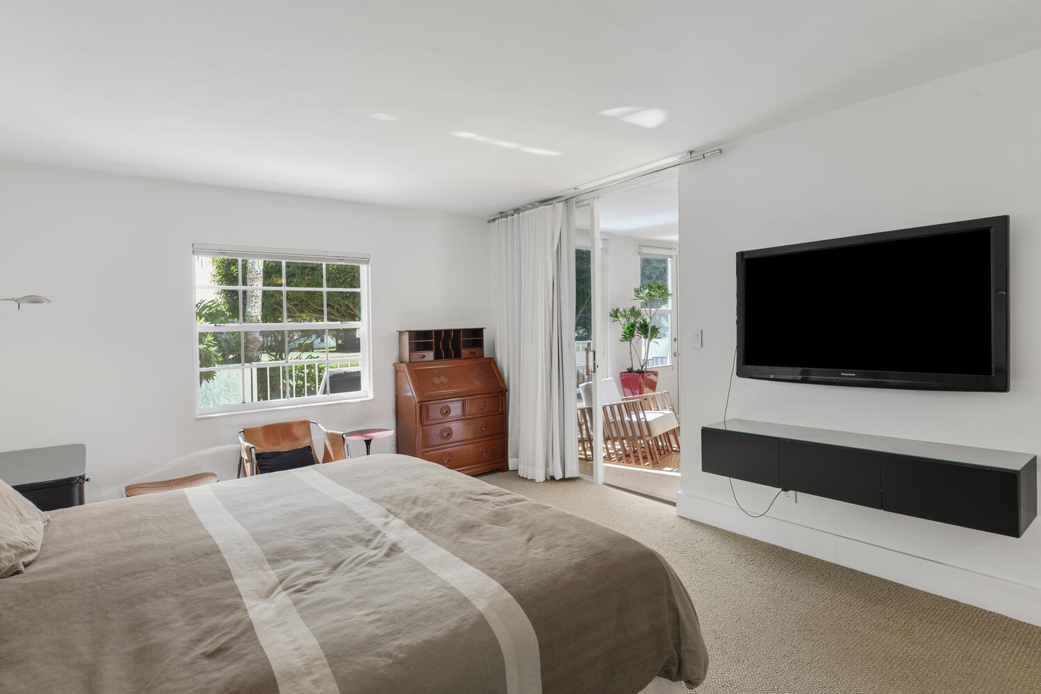 7369 Orangewood Lane, Unit 108 Boca Raton, FL 33433 - Photo 19 of 66 a bedroom with a bed and a flat screen tv