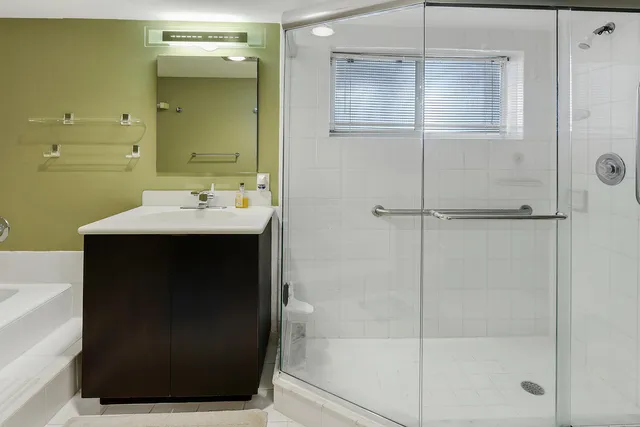 a view of a patio with table and chairs potted plants and large tree