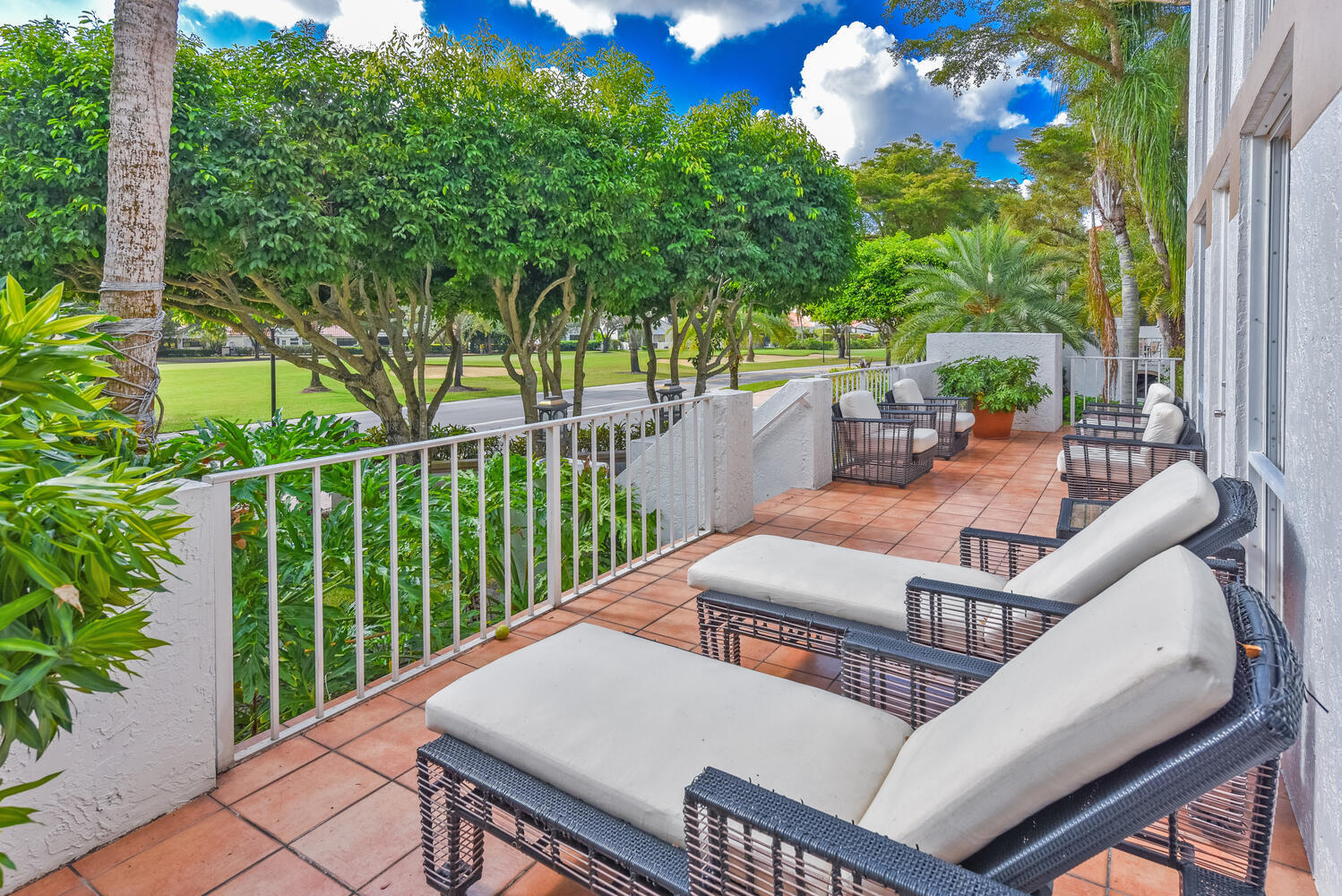 7369 Orangewood Lane, Unit 108 Boca Raton, FL 33433 - Photo 25 of 66 a view of a patio with table and chairs and potted plants