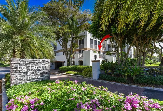 a living room with furniture a wooden floor and a flat screen tv