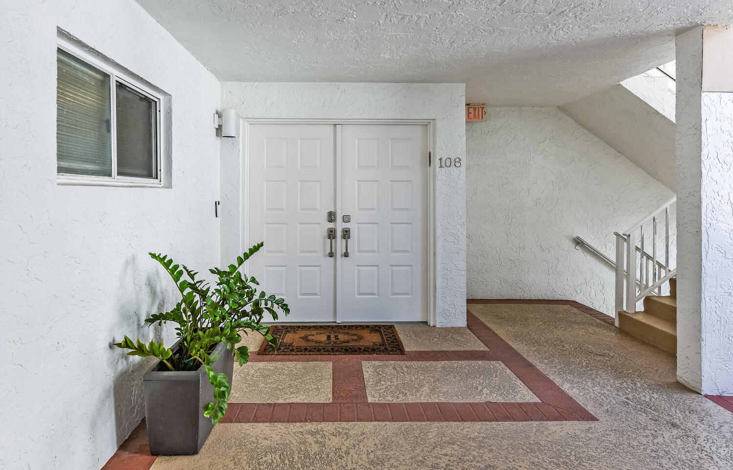 7369 Orangewood Lane, Unit 108 Boca Raton, FL 33433 - Photo 34 of 66 a view of a hallway with wooden floor and a potted plant