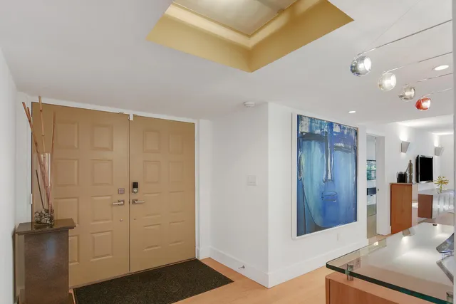 a living room with furniture a flat screen tv and a large window
