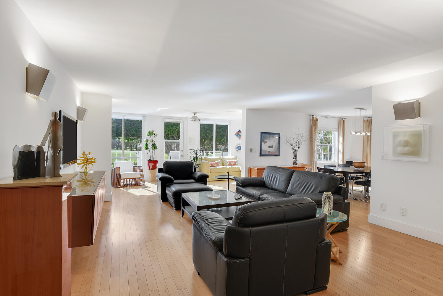 7369 Orangewood Lane, Unit 108 Boca Raton, FL 33433 - Photo 6 of 66 a living room with furniture a wooden floor and a flat screen tv