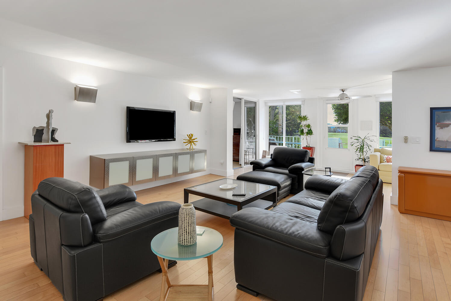 7369 Orangewood Lane, Unit 108 Boca Raton, FL 33433 - Photo 8 of 66 a living room with furniture a flat screen tv and a large window