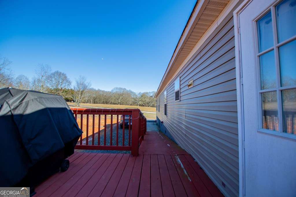 450 Glenloch Road Roopville, GA 30170 - Photo 35 of 38 a view of a balcony with wooden floor and fence and a potted plant