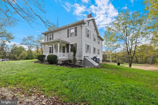 a view of a house with a yard porch and sitting area