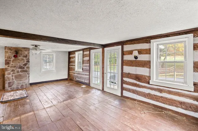 a view of a livingroom with wooden floor and cabinet