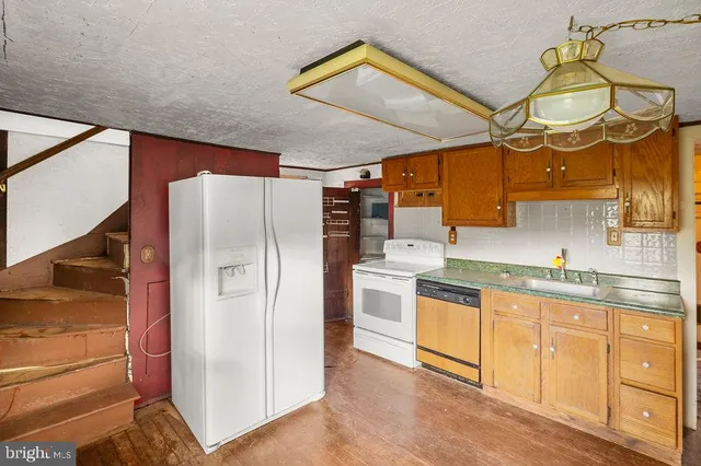 a kitchen with cabinets and stainless steel appliances