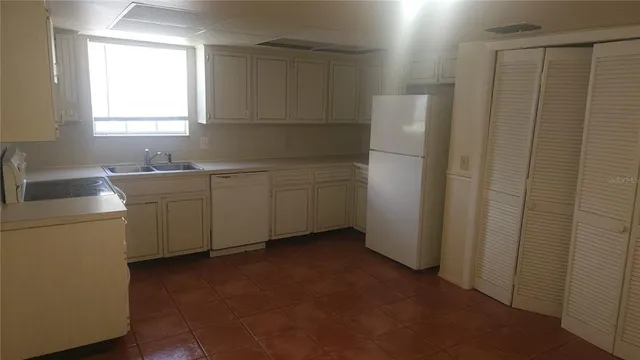 a room with a sink and a washer dryer